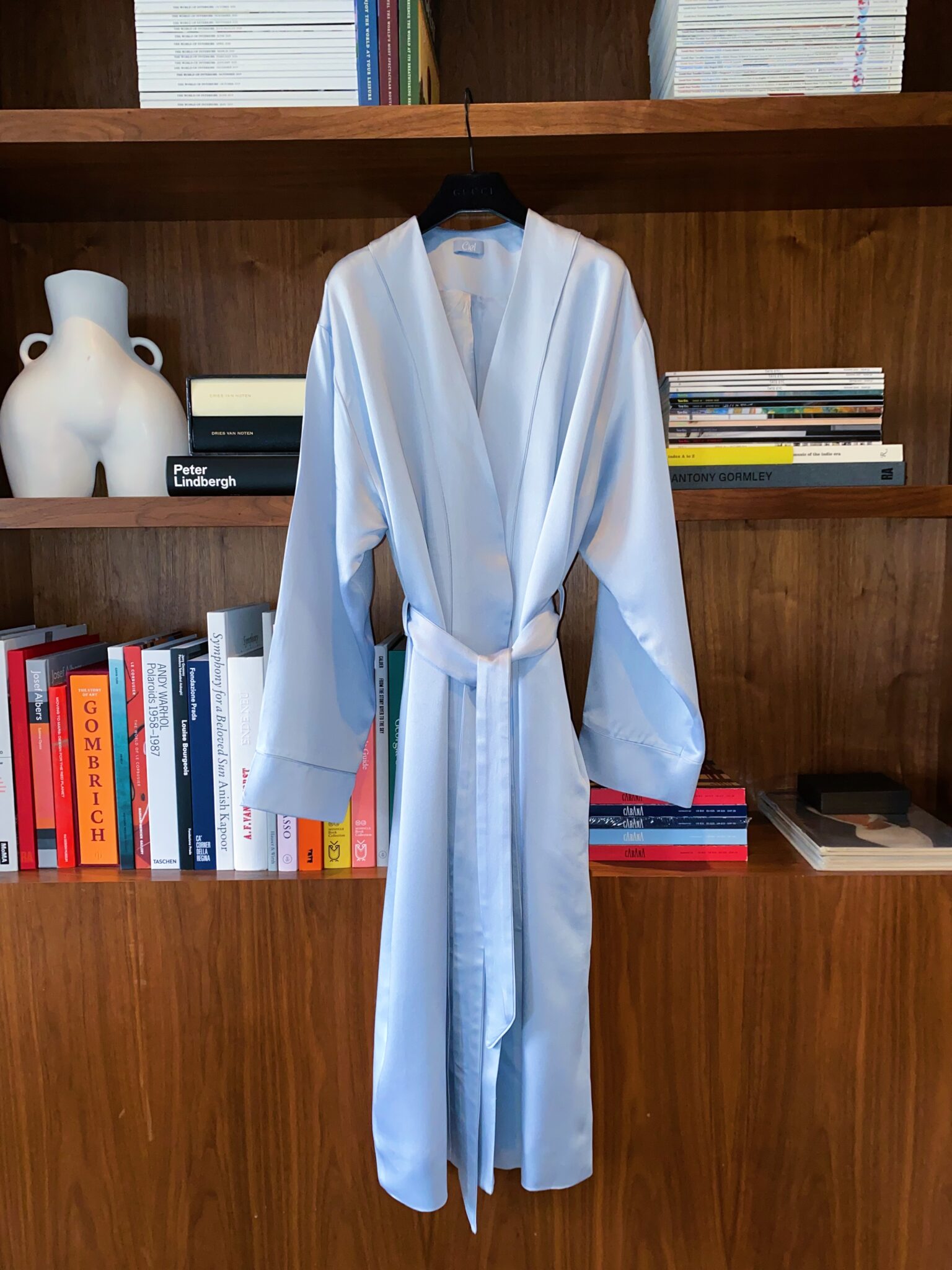 light blue robe hanging against a closet